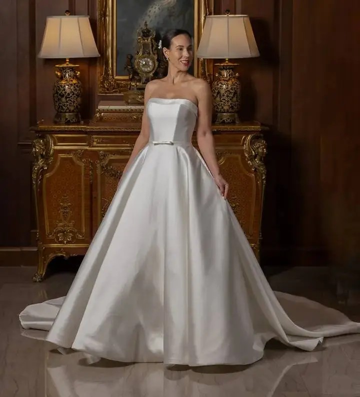 Model wearing a white gown by Ellisar Bridal